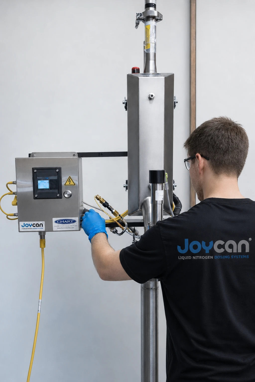 JoyCan technician refurbishing a used liquid nitrogen doser with a Chart control panel